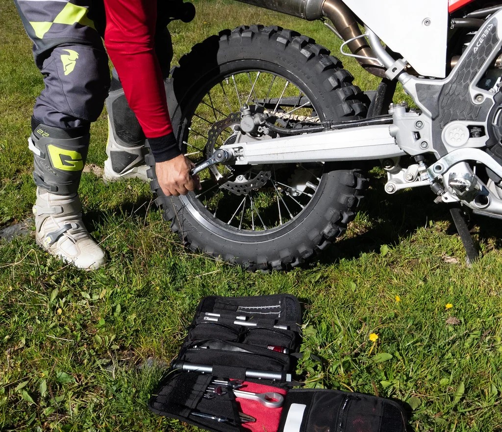 Tour mechanic performing maintenance on motorcycle fleet